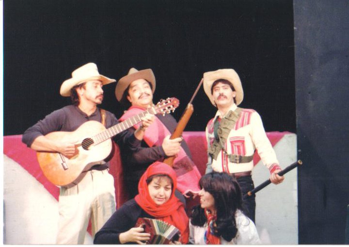 An early photo of executive artistic director, Tony Garcia (center), and fellow actors on set with instruments. An early photo of executive artistic director, Tony Garcia (center), and fellow actors on set with instruments.