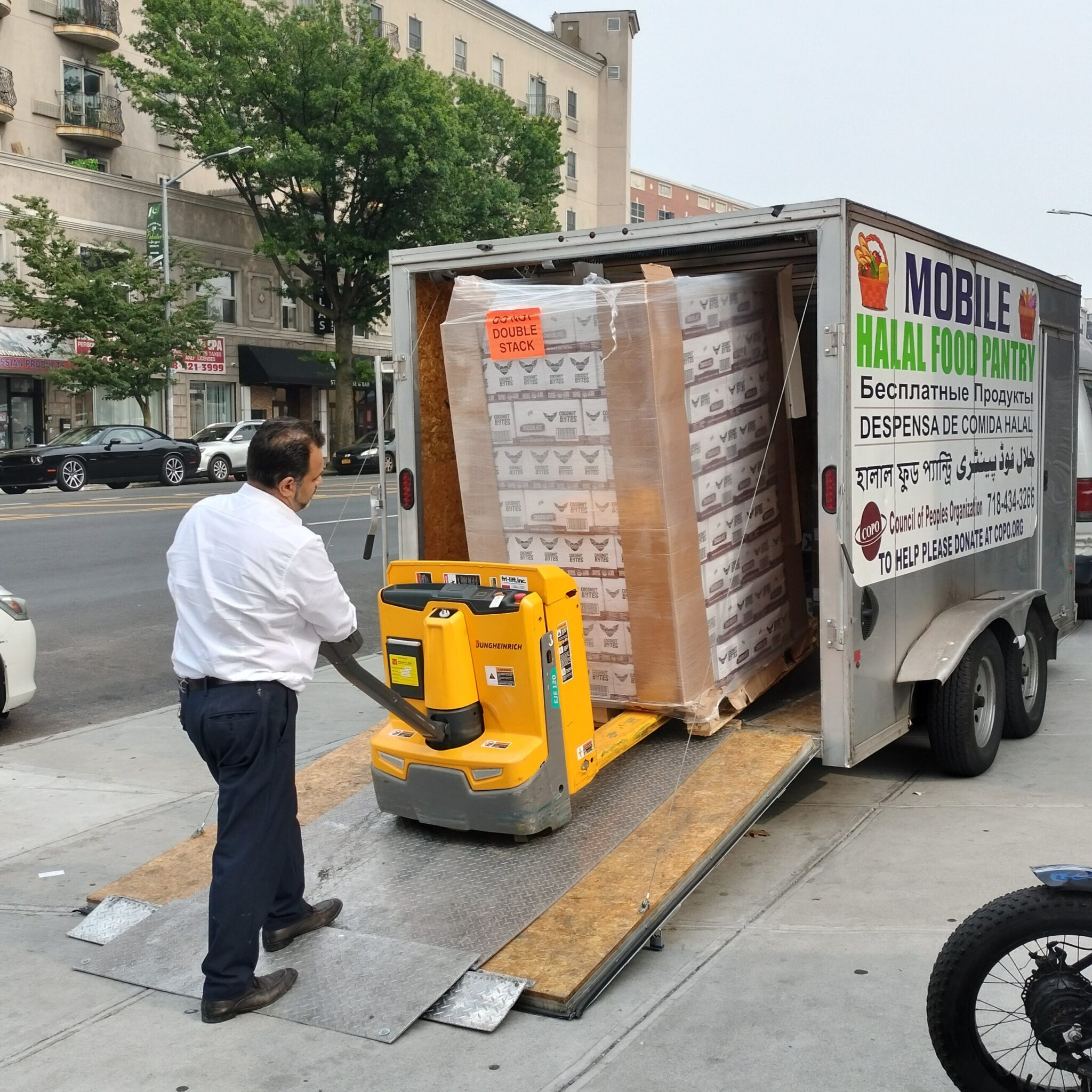 A man unloads a crate of food items for COPO's food pantry. A man unloads a crate of food items for COPO's food pantry.