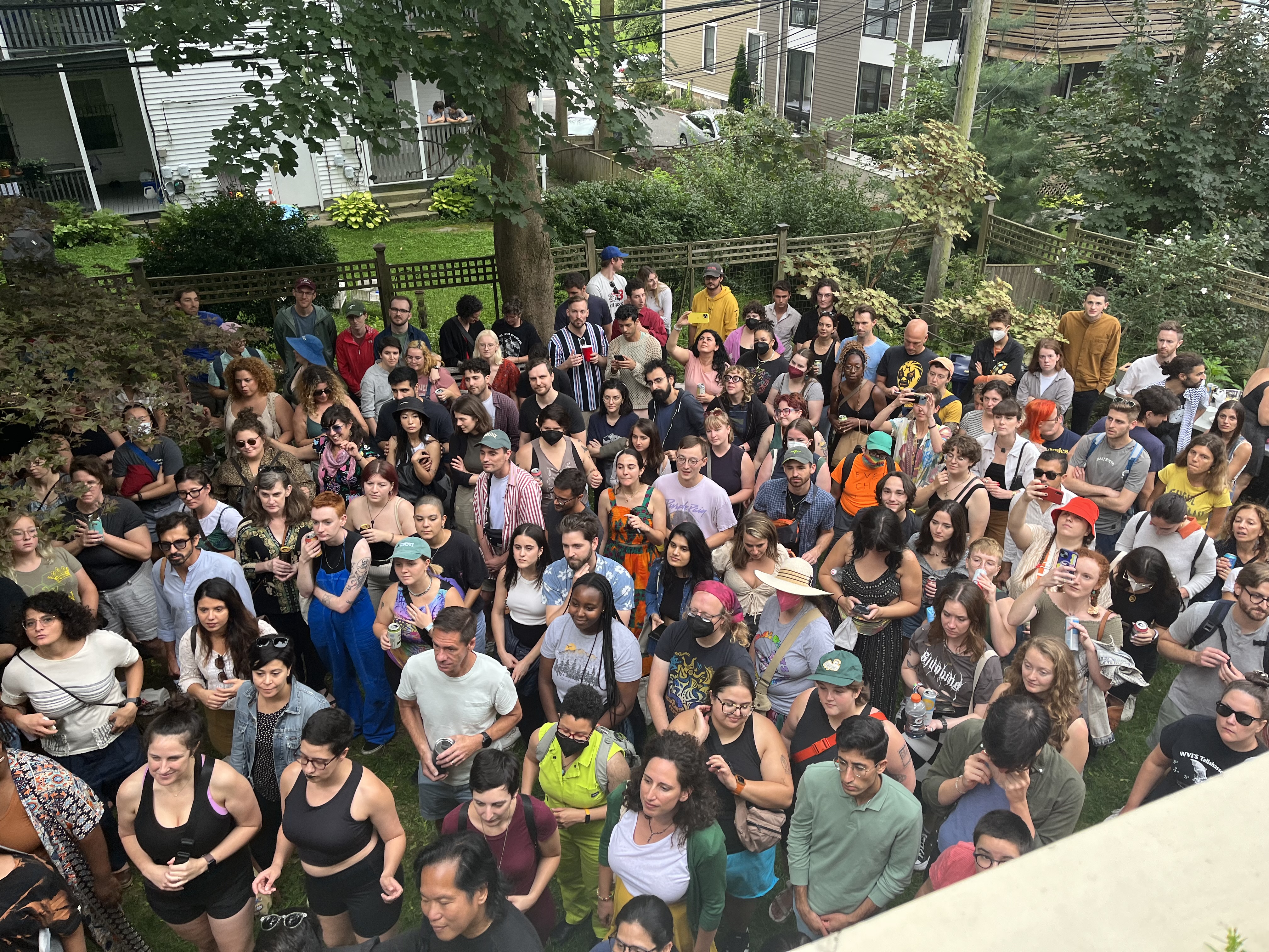 A photo of a full, vibrant crowd gathered in excitement at Dunamis' Jamaica Plain Porchfest A photo of a full, vibrant crowd gathered in excitement at Dunamis' Jamaica Plain Porchfest