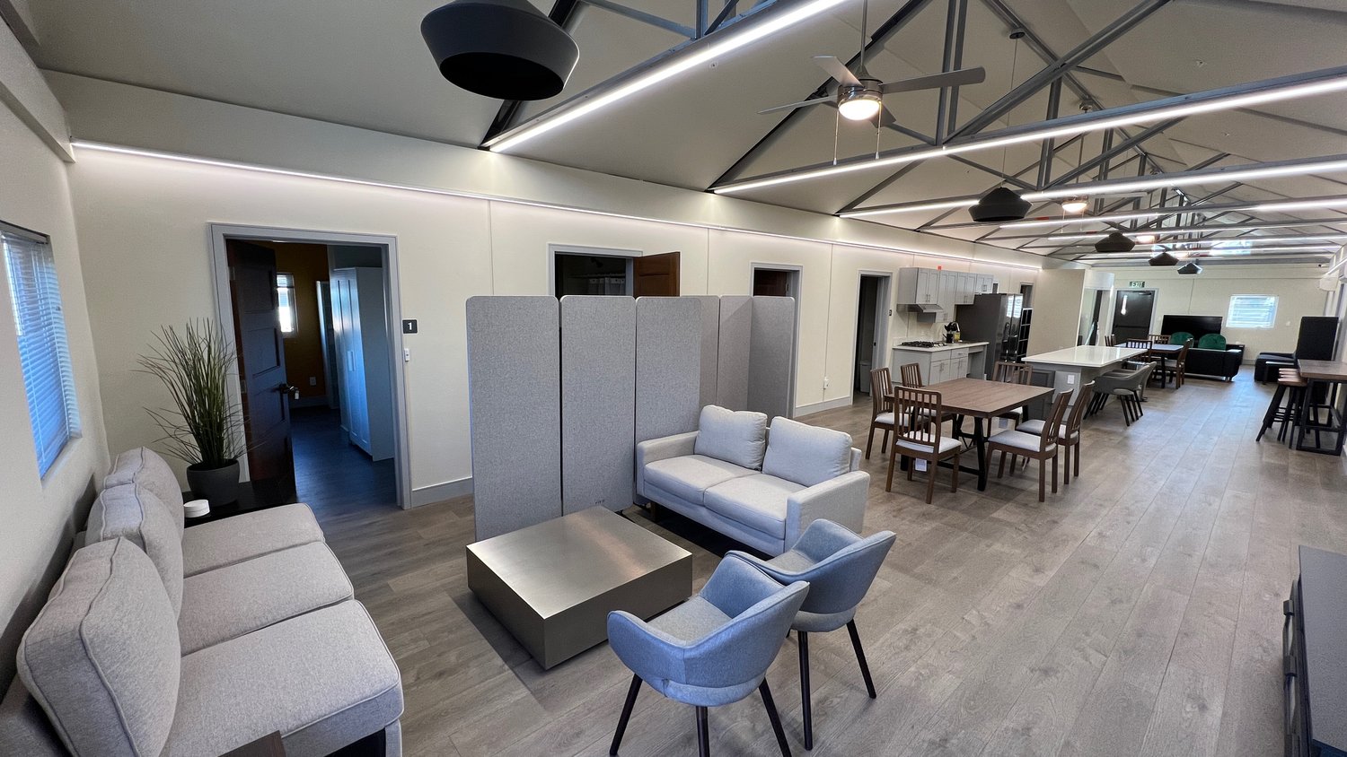 The common area of a LifeArk home, featuring couches, tables, and a shared kitchen The common area of a LifeArk home, featuring couches, tables, and a shared kitchen
