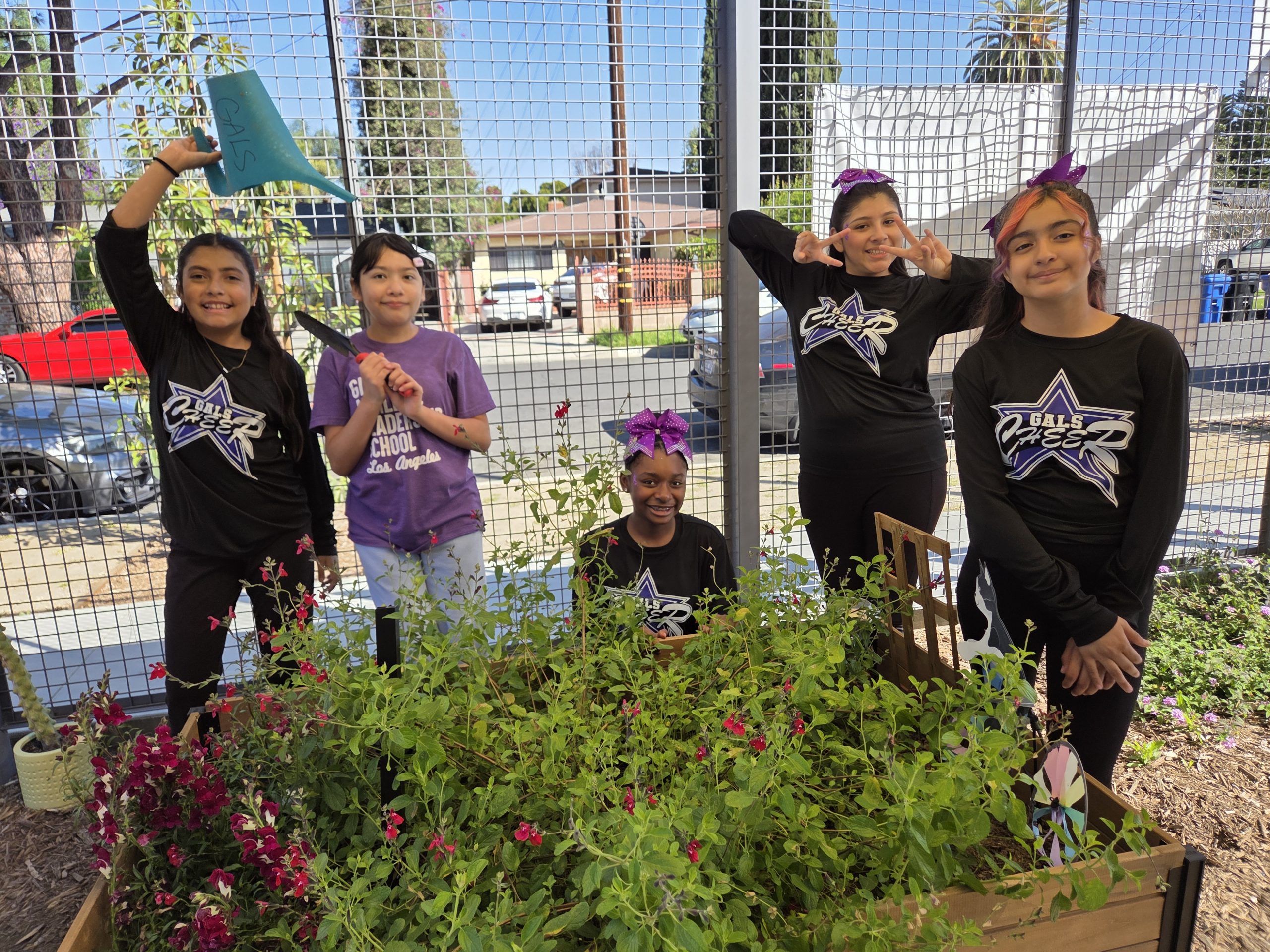 GALS LA students stand together in their school garden.