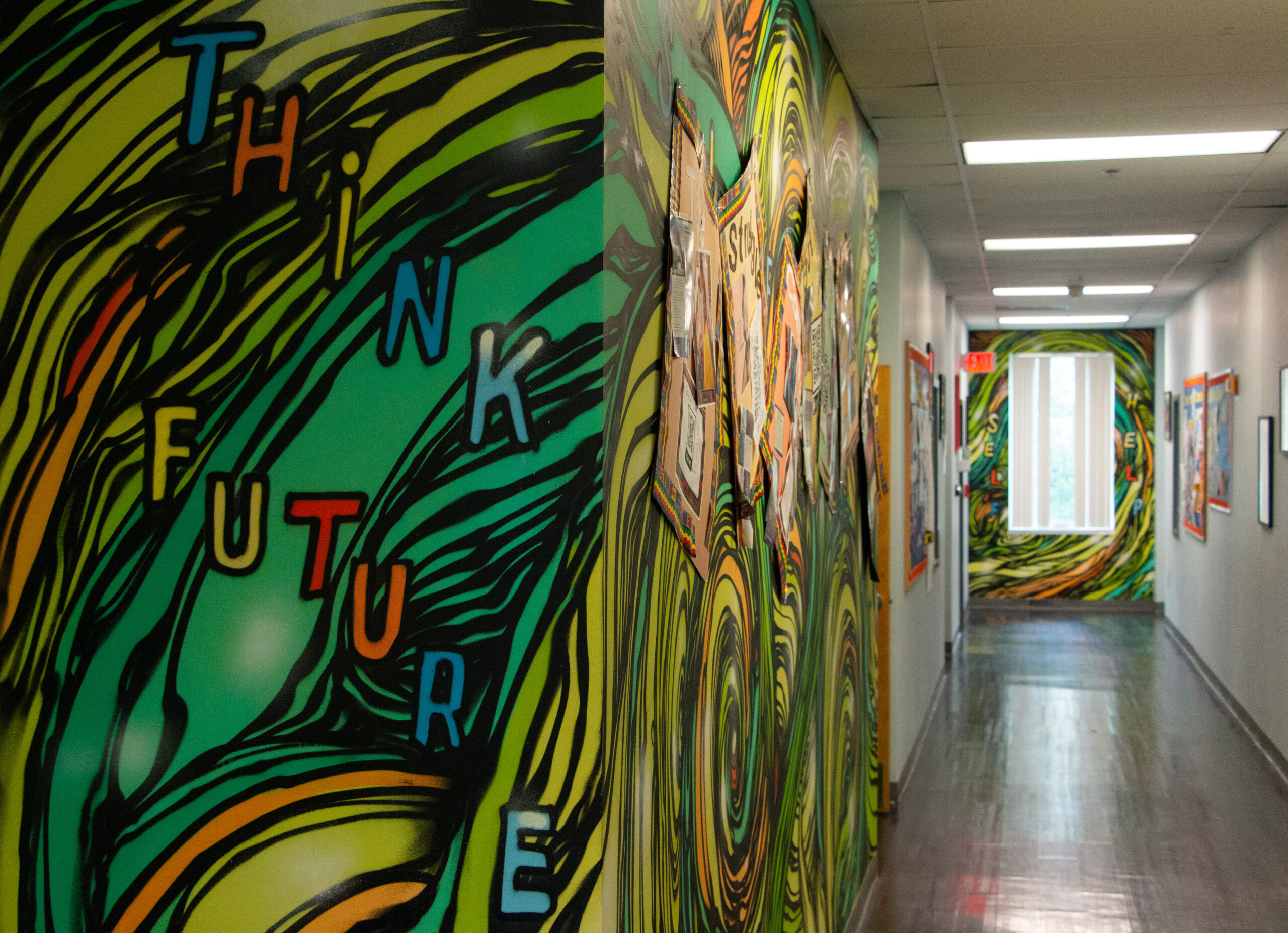 Hallway with vibrant mural art featuring swirling green and yellow patterns. The words "Think Future" are painted boldly. Bright, creative atmosphere. Hallway with vibrant mural art featuring swirling green and yellow patterns. The words "Think Future" are painted boldly. Bright, creative atmosphere.